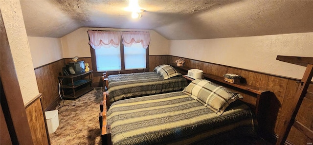 bedroom featuring light carpet, a textured ceiling, wooden walls, and lofted ceiling