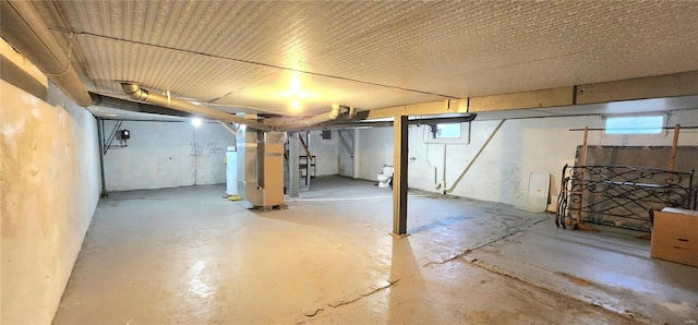 basement with heating unit and plenty of natural light