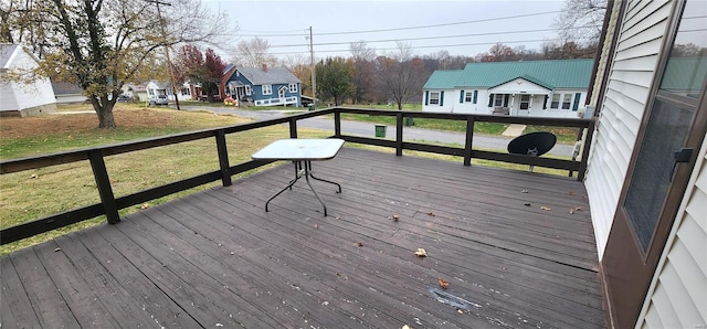 wooden terrace featuring a yard