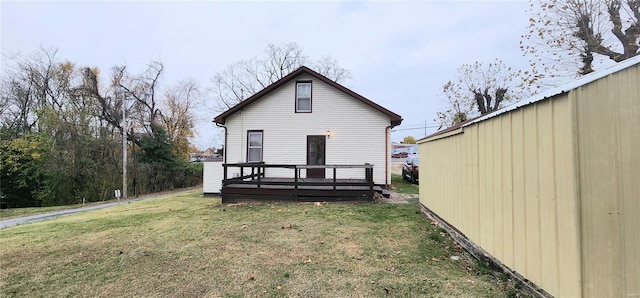 back of property featuring a yard and a deck