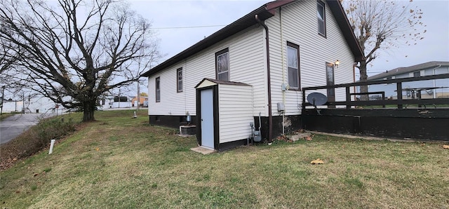 view of side of home with a lawn