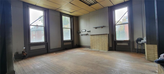 entryway with a drop ceiling and light hardwood / wood-style flooring