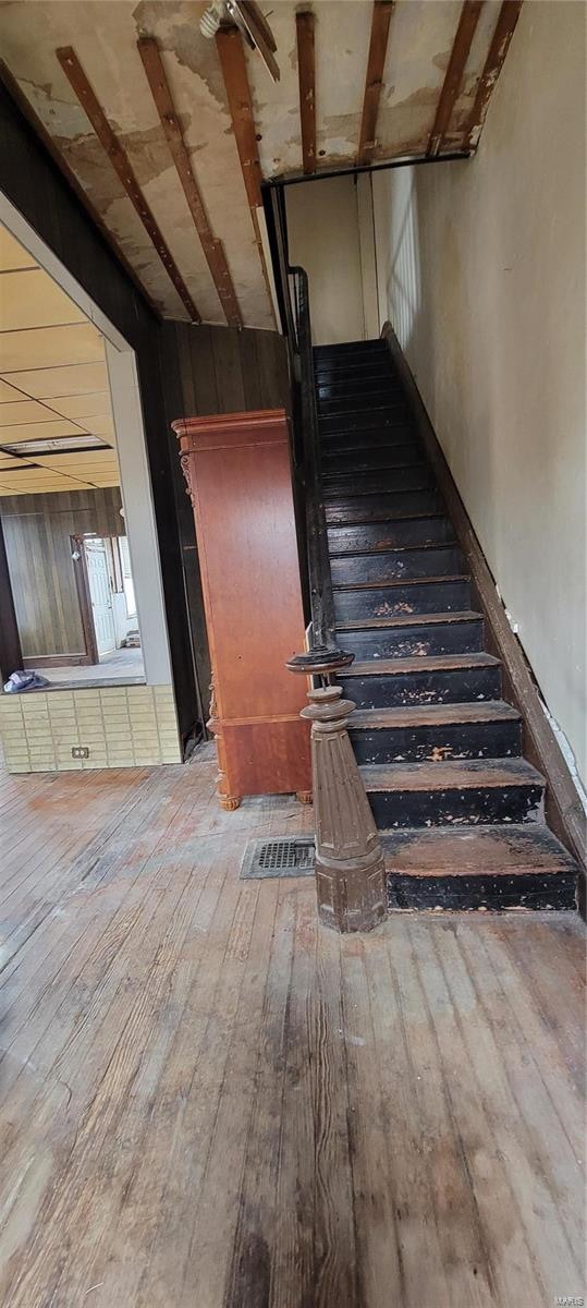 staircase with hardwood / wood-style flooring