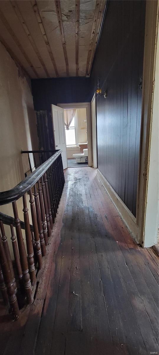 hallway with hardwood / wood-style floors