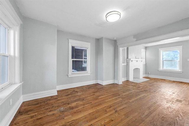 unfurnished living room featuring a fireplace and hardwood / wood-style floors