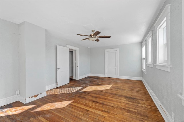 spare room featuring dark hardwood / wood-style flooring and ceiling fan