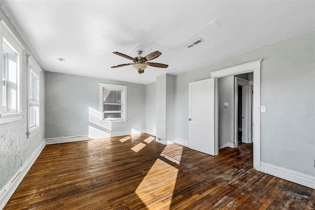 spare room featuring dark hardwood / wood-style flooring and ceiling fan