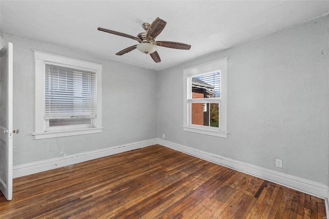 unfurnished room featuring dark hardwood / wood-style floors and ceiling fan