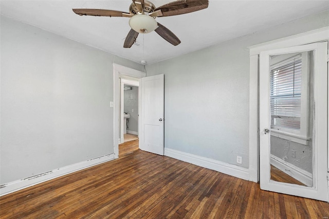 empty room featuring ceiling fan and dark hardwood / wood-style floors