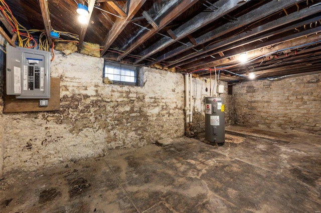 basement featuring electric panel and water heater