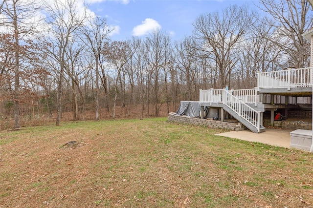 view of yard with a patio area and a wooden deck