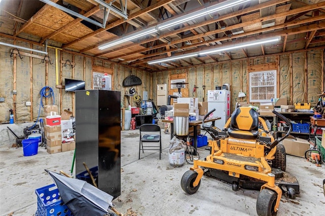 interior space featuring a workshop area and white fridge