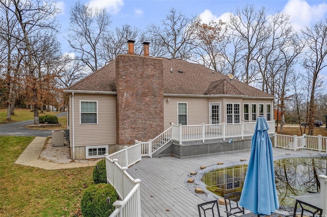 back of house featuring a wooden deck