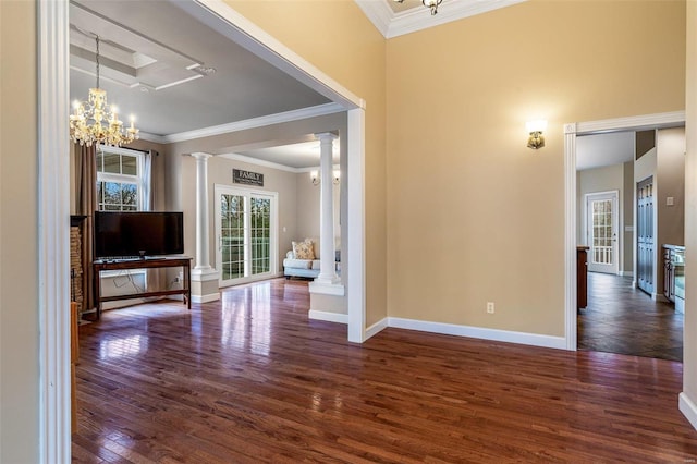 living room with ornate columns, crown molding, dark wood-type flooring, and a notable chandelier