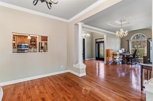 dining area featuring ornate columns, crown molding, a notable chandelier, and hardwood / wood-style flooring