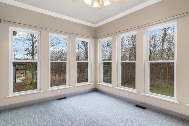 unfurnished sunroom with plenty of natural light and ceiling fan