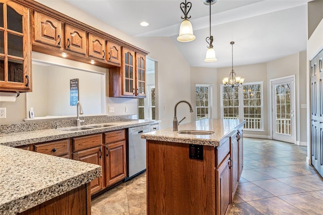 kitchen with an inviting chandelier, stainless steel dishwasher, a kitchen island with sink, and sink