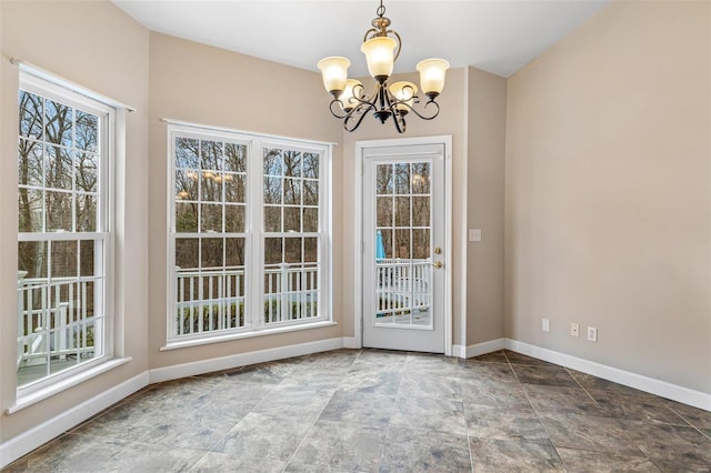 unfurnished dining area featuring an inviting chandelier