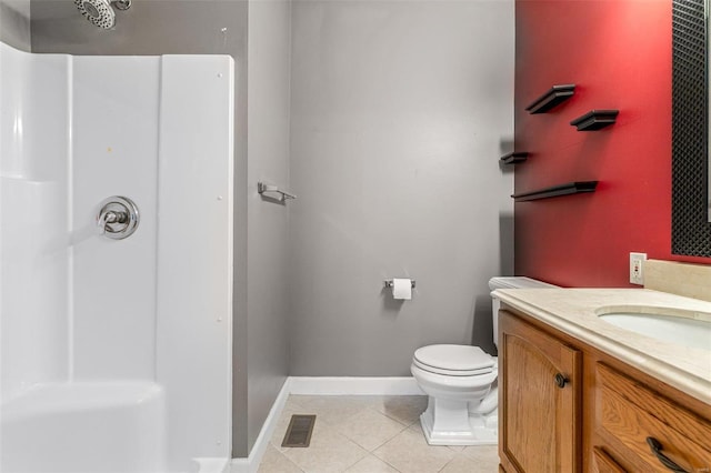 bathroom with tile patterned floors, vanity, toilet, and walk in shower