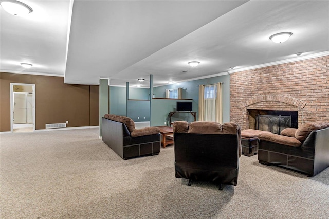 living room with crown molding, carpet, and a brick fireplace