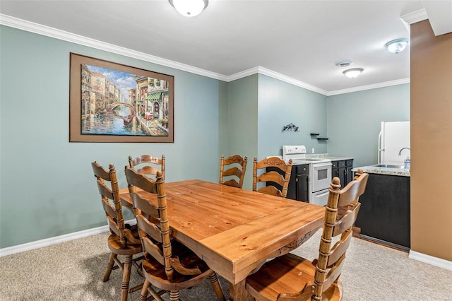 dining room with crown molding, sink, and carpet floors