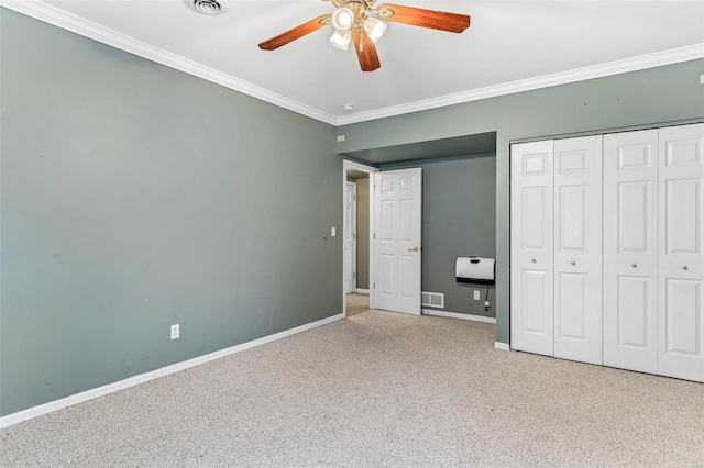 unfurnished bedroom featuring a closet, light colored carpet, ceiling fan, and crown molding