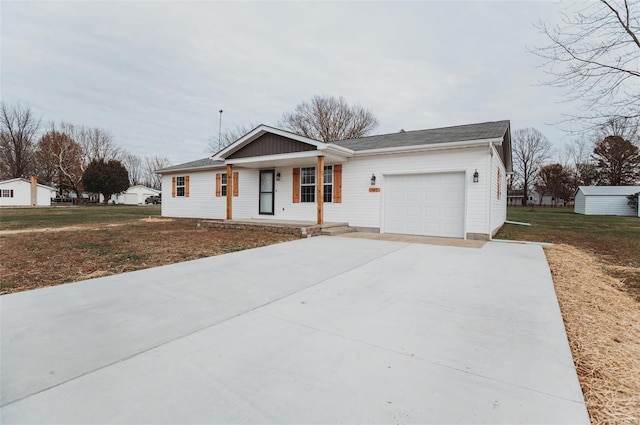 ranch-style home featuring a garage, covered porch, and a front yard