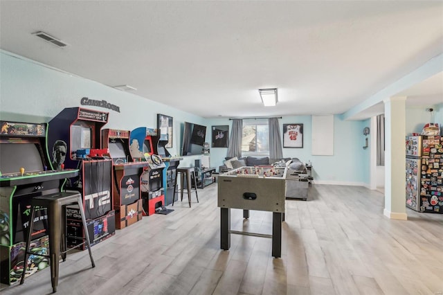 rec room with light hardwood / wood-style flooring