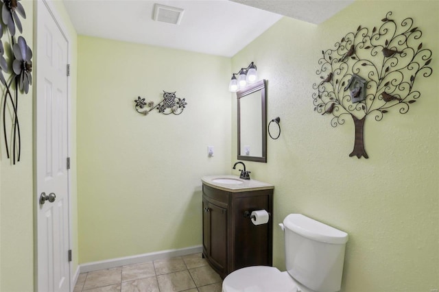 bathroom featuring toilet, vanity, and tile patterned flooring