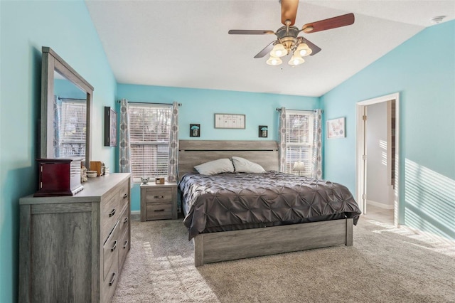 bedroom featuring ceiling fan, light colored carpet, and vaulted ceiling