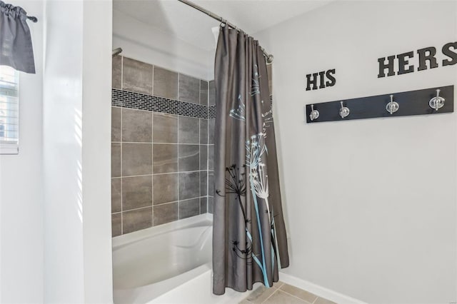 bathroom with tile patterned floors and shower / bath combo