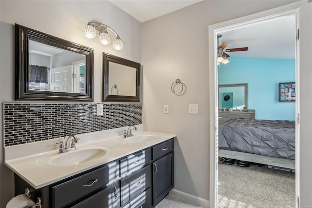 bathroom with decorative backsplash, vanity, ceiling fan, and tile patterned flooring