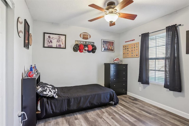 bedroom featuring ceiling fan and hardwood / wood-style flooring