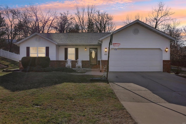 ranch-style home with a garage, a lawn, and a porch