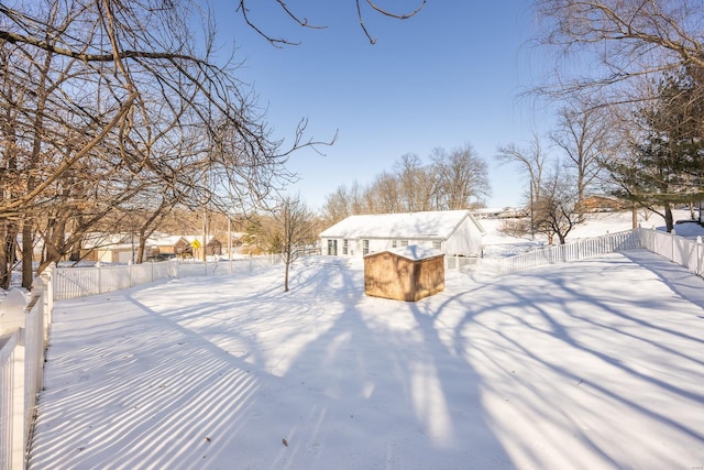 yard covered in snow with a shed