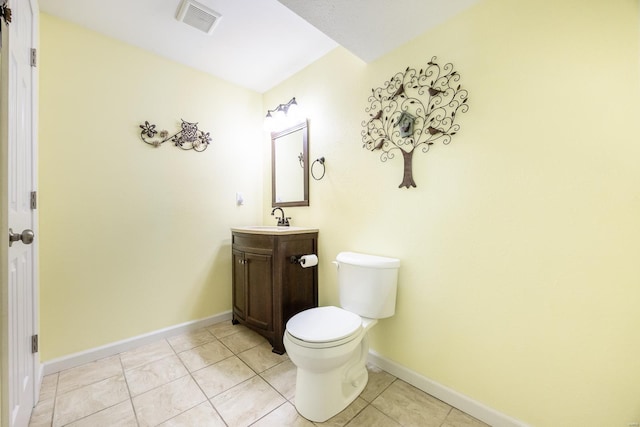 bathroom featuring toilet, vanity, and tile patterned flooring