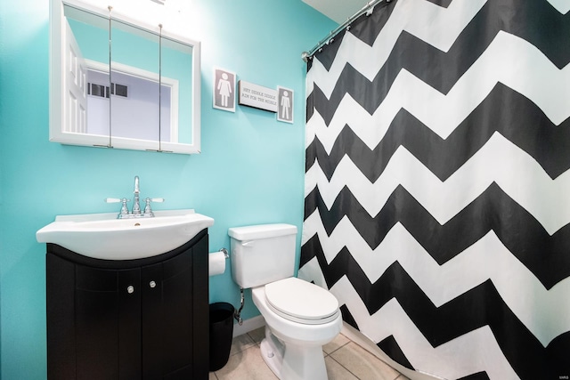 bathroom with toilet, vanity, tile patterned flooring, and curtained shower