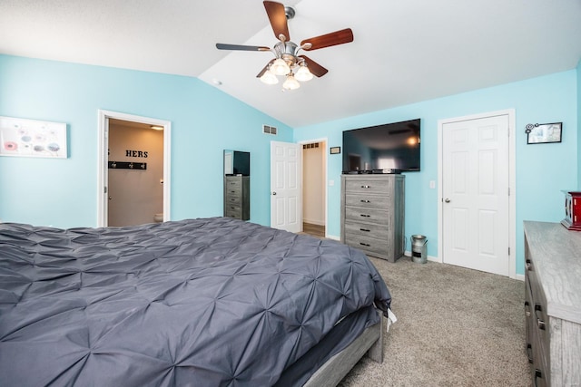 bedroom featuring ceiling fan, ensuite bath, vaulted ceiling, and carpet floors