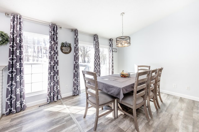 dining space with a chandelier and light wood-type flooring