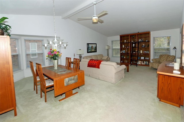 dining room with ceiling fan with notable chandelier, lofted ceiling with beams, and light colored carpet