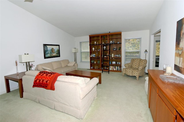 carpeted living room featuring vaulted ceiling