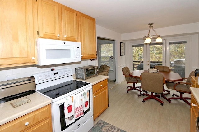 kitchen featuring french doors, light brown cabinetry, white appliances, pendant lighting, and light hardwood / wood-style flooring