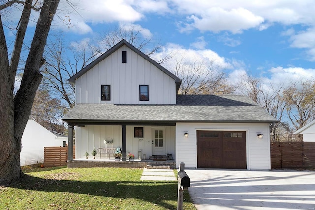 modern farmhouse with a front lawn, covered porch, and a garage