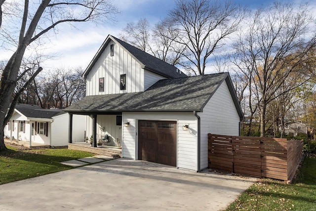 modern inspired farmhouse with a front lawn and a garage