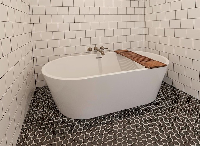 bathroom with tile patterned floors, tile walls, and a bathing tub