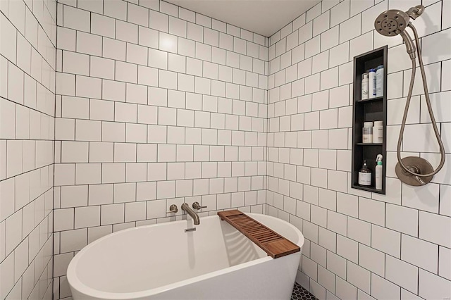 bathroom featuring a bathtub and tile walls