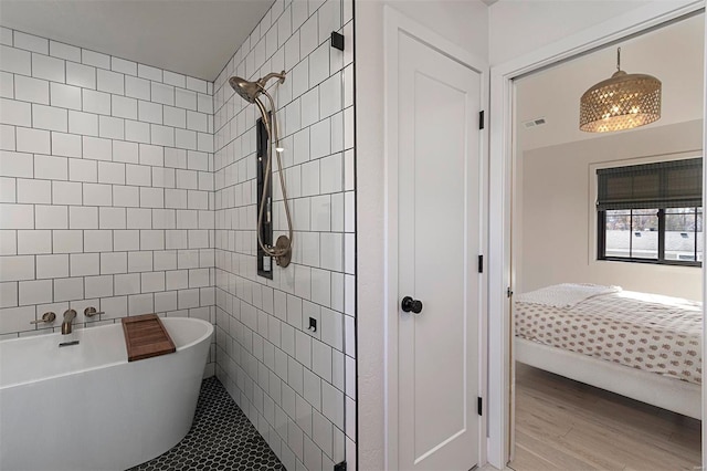 bathroom with independent shower and bath and wood-type flooring