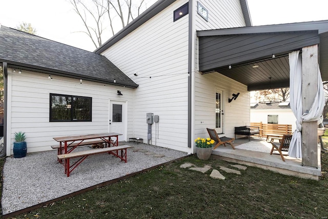 rear view of house featuring a lawn and a patio area