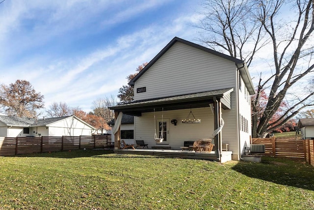 rear view of house featuring a lawn, central air condition unit, and a patio