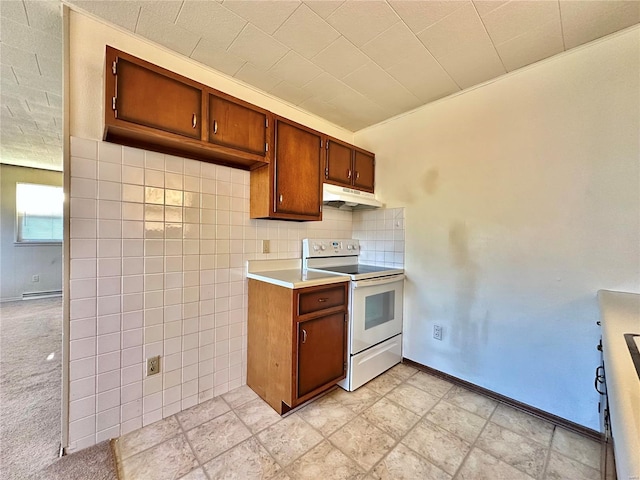 kitchen featuring white range with electric stovetop and tile walls